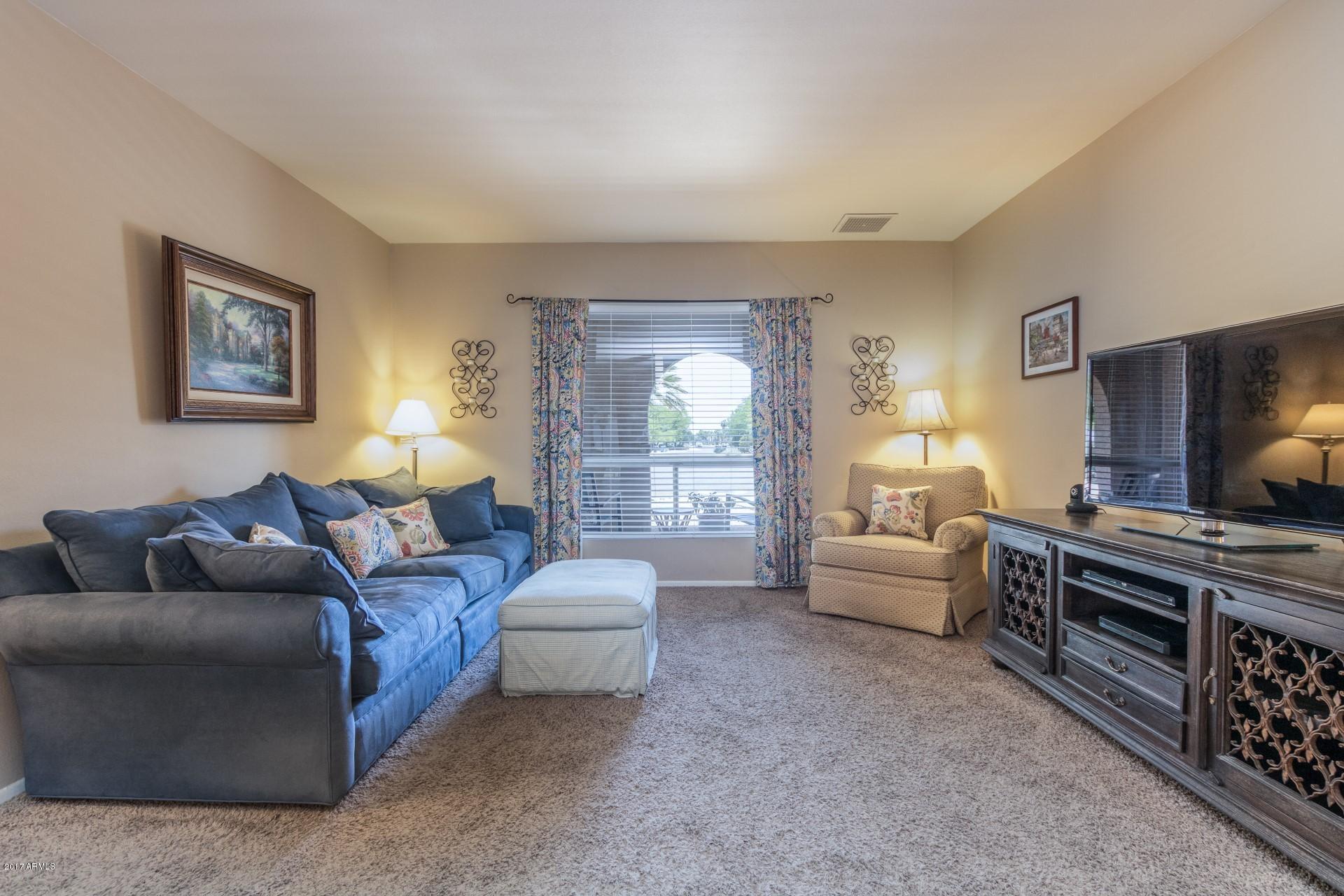 3717 East Yucca Street Phoenix, AZ 85028 - Photo 5 of 36 a living room with furniture and a flat screen tv