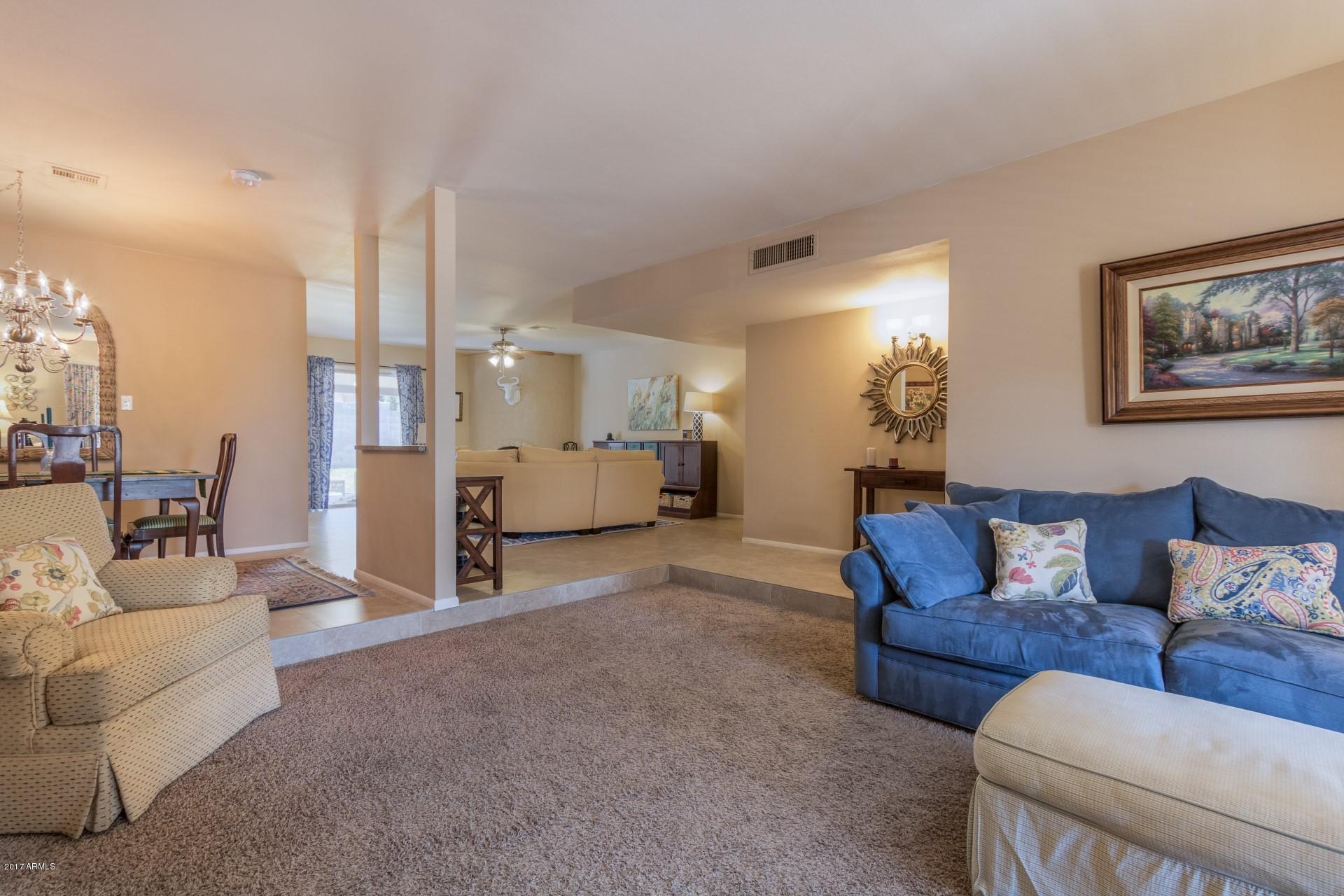 3717 East Yucca Street Phoenix, AZ 85028 - Photo 6 of 36 a living room with furniture and a chandelier