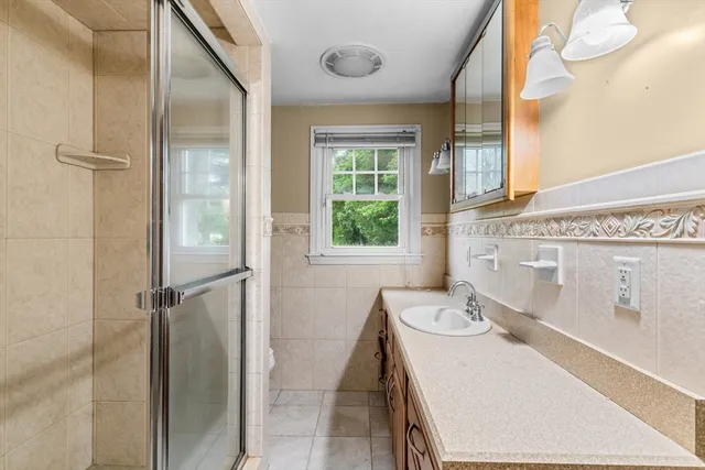 a bathroom with a sink vanity granite and a mirror