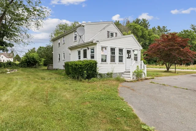 a front view of a house with a garden