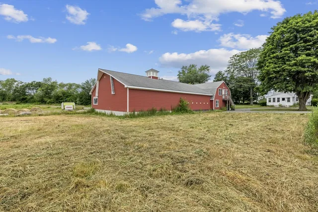 a view of a house with a yard and sitting area