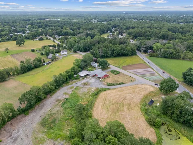 an aerial view of residential houses with outdoor space and river