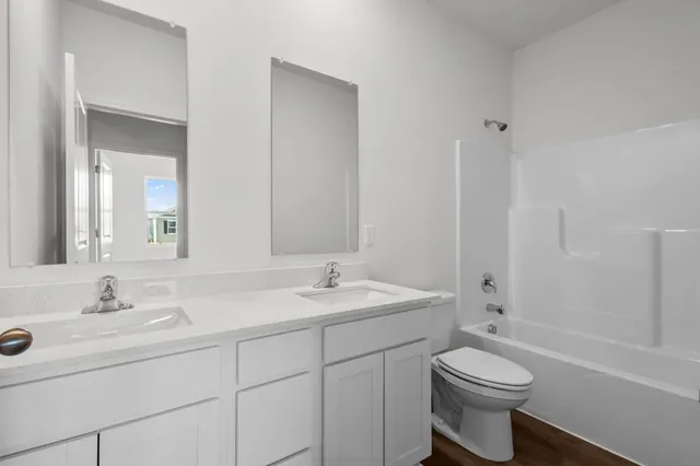 a bathroom with a sink toilet a mirror and shower