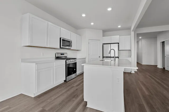 a kitchen with cabinets and stainless steel appliances