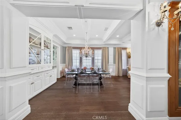a view of a dining room with furniture wooden floor and chandelier