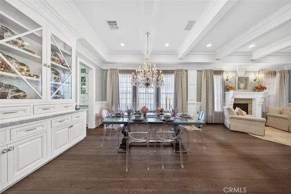 a view of a dining room with furniture wooden floor and chandelier