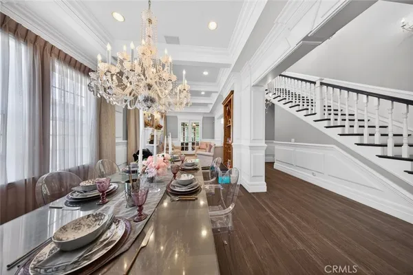 a kitchen with stainless steel appliances granite countertop a sink a stove and a wooden floors