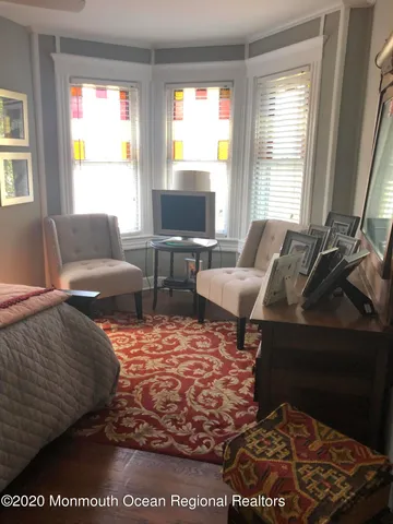 a living room with furniture rug and window