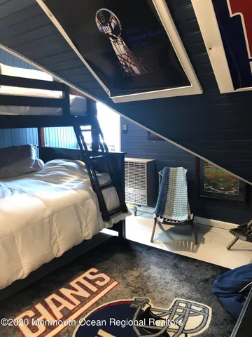 a bed sitting in a bedroom next to a window