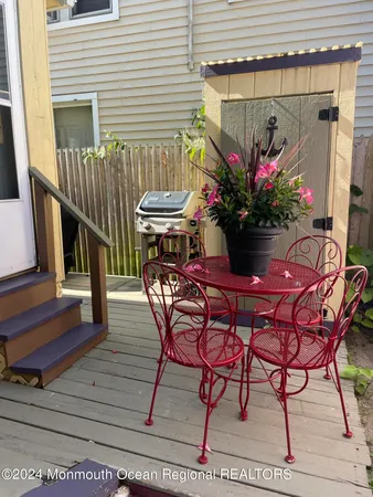 a view of a chairs and tables in the back yard of the house