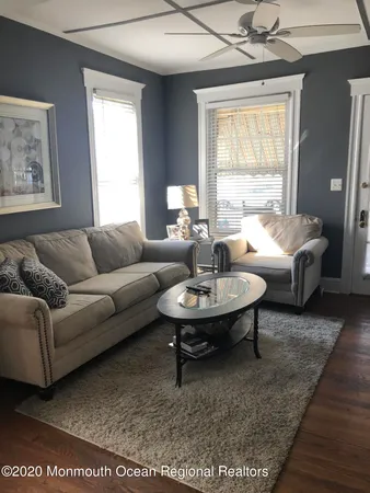 a living room with furniture a window and a table