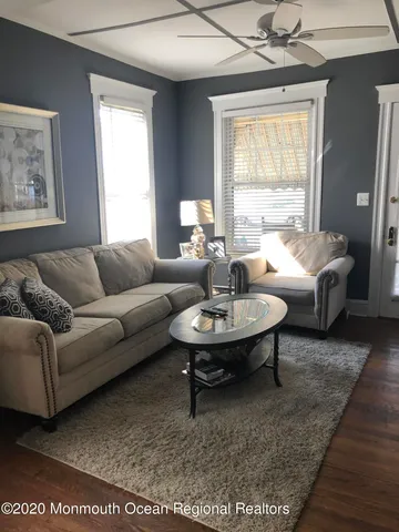 a living room with furniture a window and a table