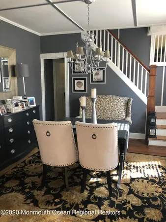 a view of a dining room with furniture wooden floor and chandelier