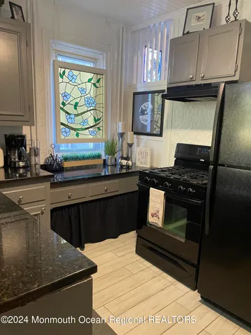 a kitchen with a sink stove and microwave