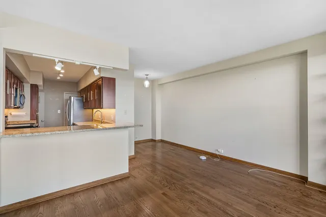 a view of a kitchen with a sink and a refrigerator