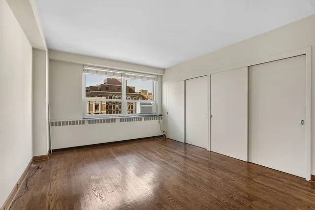 a view of wooden floor and windows in a room