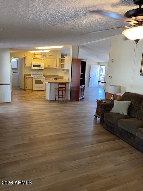 301 South Signal Butte Road, Unit 1124 Apache Junction, AZ 85120 - Photo 11 of 41 a living room with furniture and kitchen view