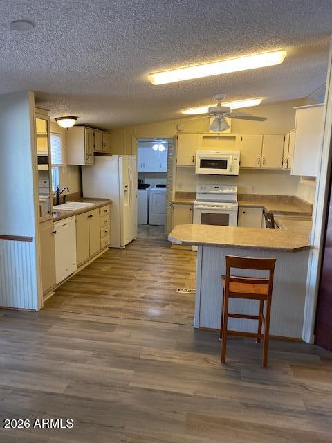 301 South Signal Butte Road, Unit 1124 Apache Junction, AZ 85120 - Photo 12 of 41 a kitchen with stainless steel appliances wooden floor a stove and a refrigerator