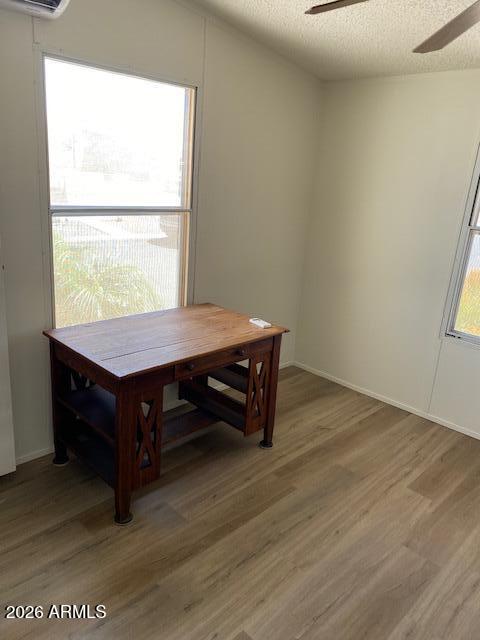 301 South Signal Butte Road, Unit 1124 Apache Junction, AZ 85120 - Photo 26 of 41 a room with a wooden floor and furniture