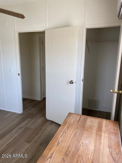 301 South Signal Butte Road, Unit 1124 Apache Junction, AZ 85120 - Photo 28 of 41 a bedroom with a bed and wooden floor