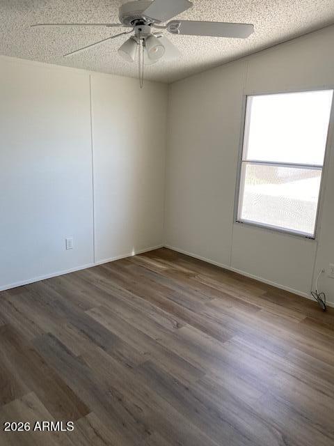 301 South Signal Butte Road, Unit 1124 Apache Junction, AZ 85120 - Photo 29 of 41 an empty room with wooden floor fan and windows
