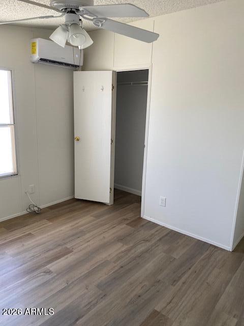 301 South Signal Butte Road, Unit 1124 Apache Junction, AZ 85120 - Photo 30 of 41 an empty room with wooden floor and chandelier fan