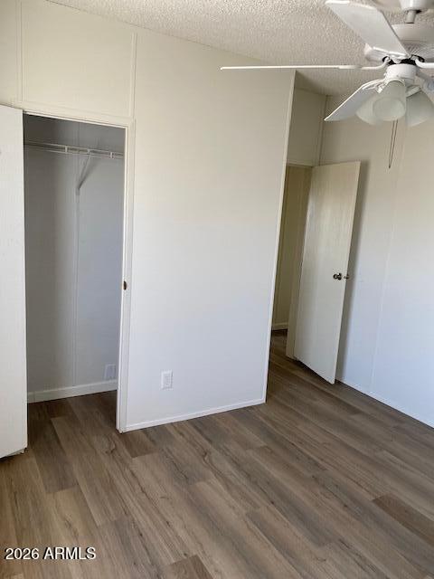 301 South Signal Butte Road, Unit 1124 Apache Junction, AZ 85120 - Photo 31 of 41 an empty room with wooden floor and fan