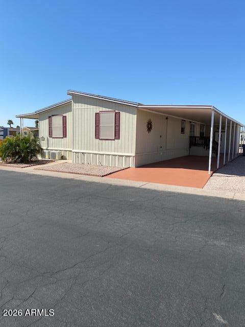 301 South Signal Butte Road, Unit 1124 Apache Junction, AZ 85120 - Photo 34 of 41 a front view of a house with large trees
