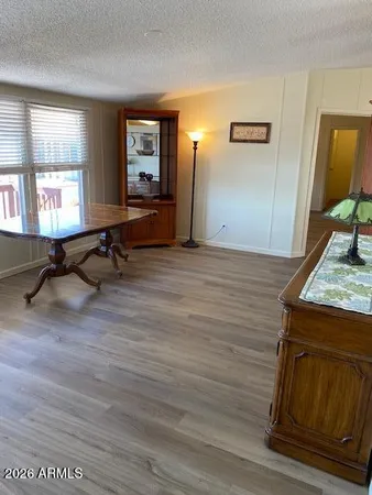 a view of a livingroom with wooden floor and a window