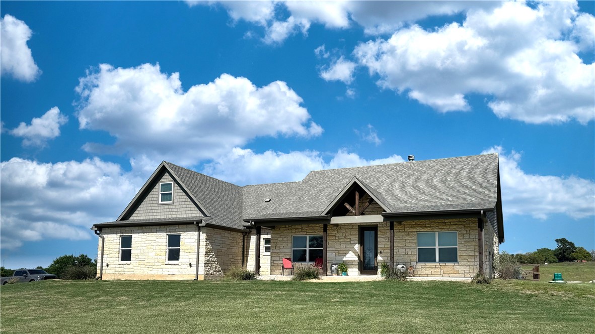 a front view of a house with a garden