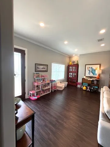a dining room with furniture and wooden floor