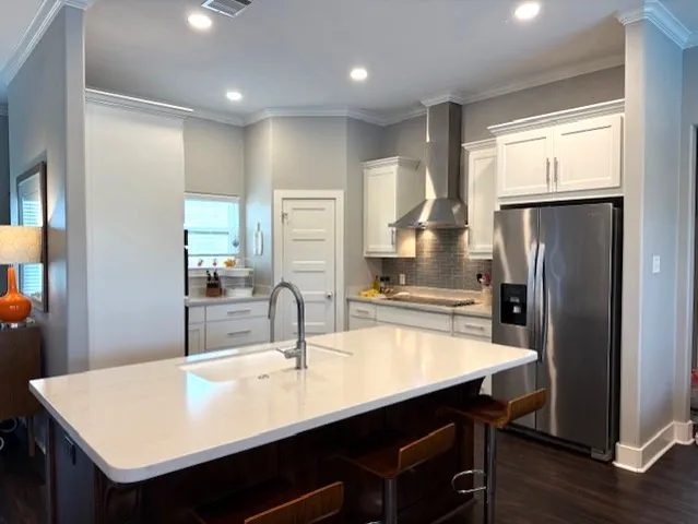 a kitchen with white cabinets and appliances