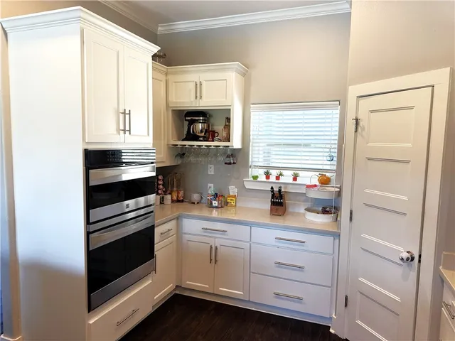a view of a hallway with wooden floor and closet