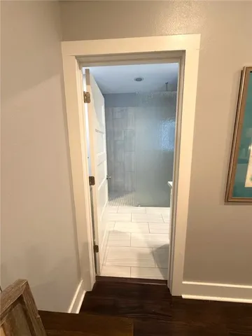 a kitchen with a sink and wooden floor