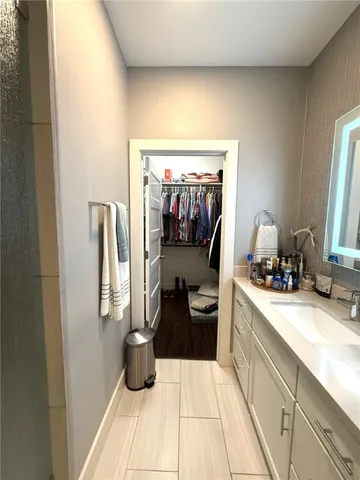 a bathroom with a double vanity sink toilet mirror and window