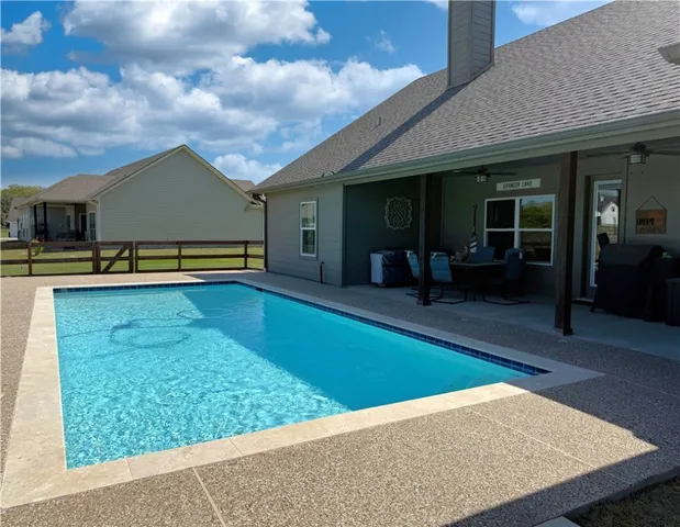 a view of a house with a backyard porch and sitting area