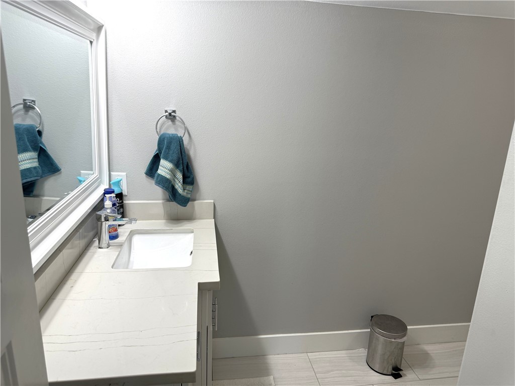 928 Azalea Drive Franklin, TX 77856 - Photo 31 of 37 a bathroom with a sink and mirror