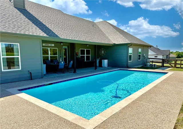 a view of a swimming pool with a lake view