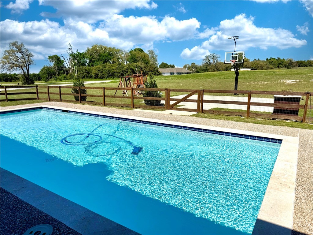 928 Azalea Drive Franklin, TX 77856 - Photo 5 of 37 a view of a swimming pool with a lake view