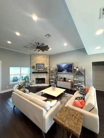 a living room with fireplace furniture and a wooden floor