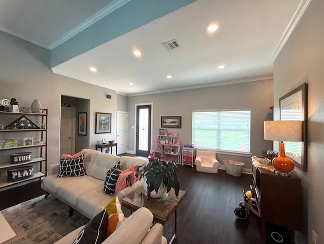 a view of a room with wooden floor and furniture