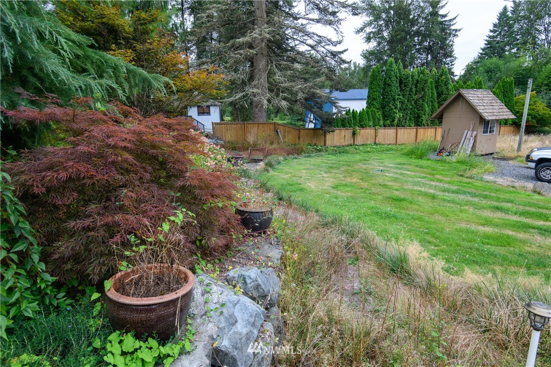 2710 Callow Road Lake Stevens, WA 98258 - Photo 14 of 37 a view of a backyard with plants and a fountain