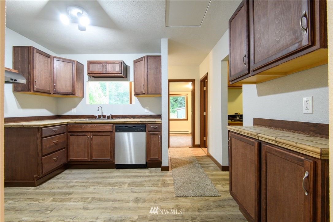 2710 Callow Road Lake Stevens, WA 98258 - Photo 21 of 37 a kitchen with stainless steel appliances granite countertop a stove a sink and a microwave