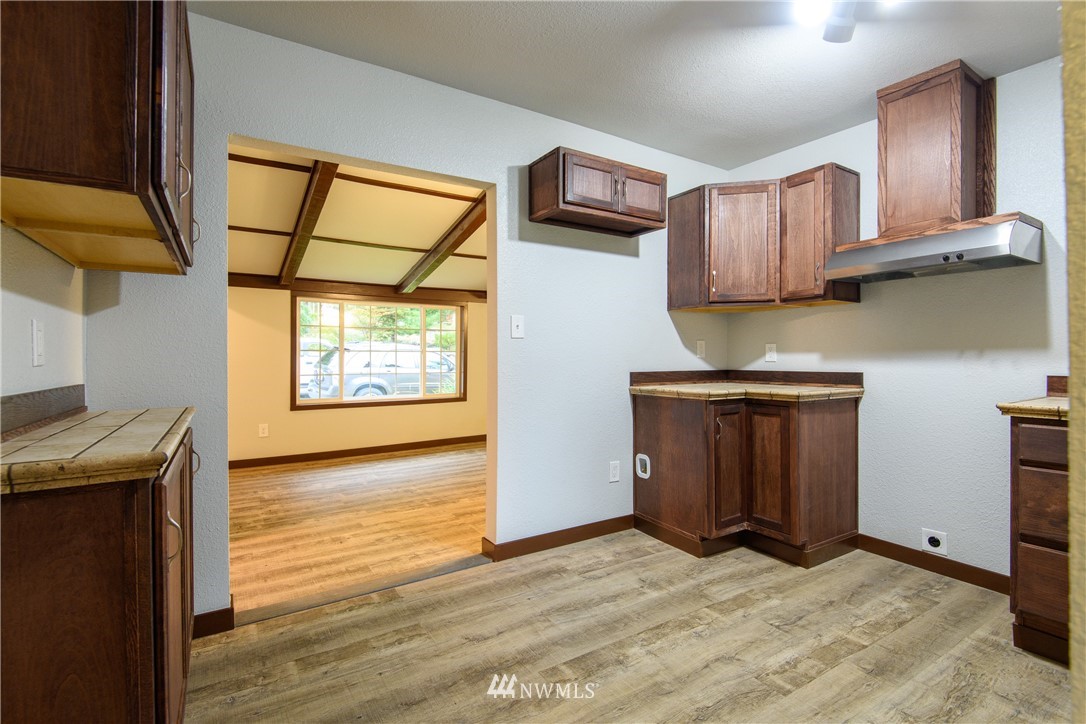 2710 Callow Road Lake Stevens, WA 98258 - Photo 22 of 37 a view of a kitchen with wooden floor and electronic appliances