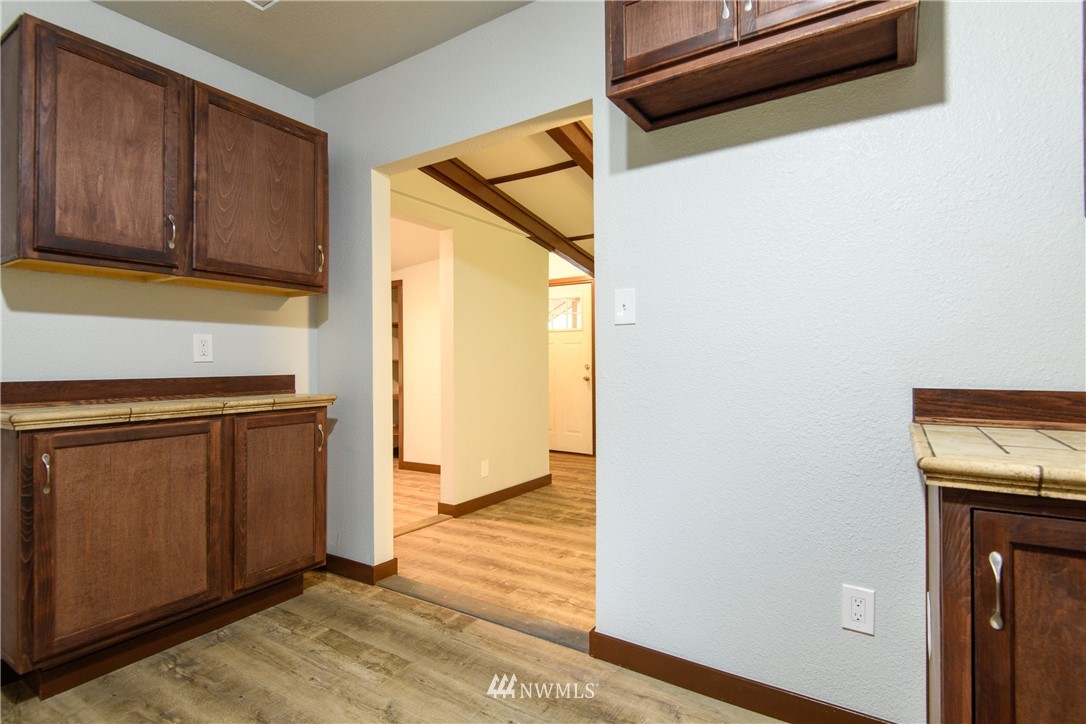 2710 Callow Road Lake Stevens, WA 98258 - Photo 24 of 37 a view of a kitchen with wooden floor and cabinets