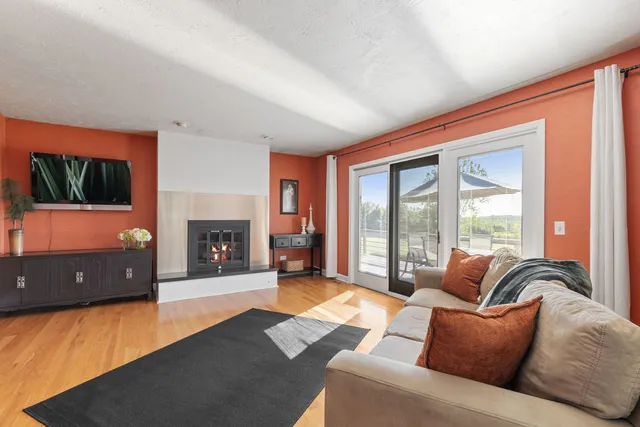 a living room with furniture window and a flat screen tv