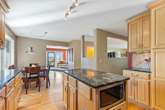 a kitchen that has a table and chairs in it