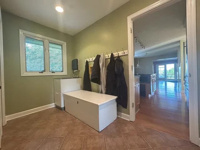 a room with a wooden floor and a bathroom