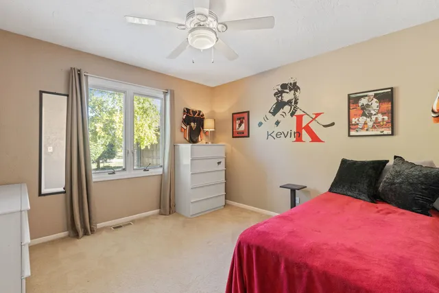 a bedroom with a bed and a window