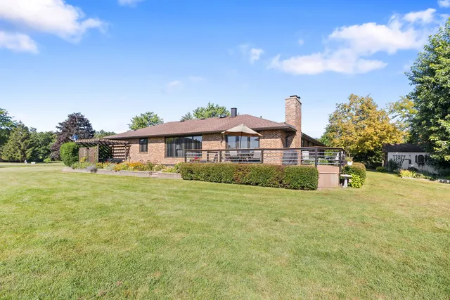 an aerial view of a house with swimming pool garden and mountain view
